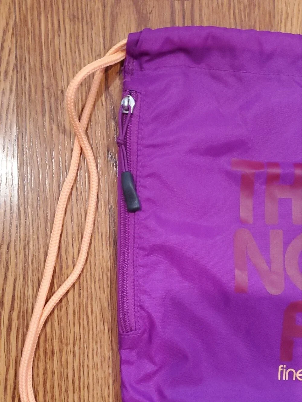 The North Face Purple Drawstring Backpack with Peach Cords With Zippered Pocket
